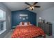 Cozy bedroom with ceiling fan, blue accent wall, and a queen bed adorned with a patterned comforter at 1002 Elm Hall Cir, Summerville, SC 29483