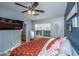 Cozy bedroom with ceiling fan, blue accent wall, and a queen bed adorned with a patterned comforter at 1002 Elm Hall Cir, Summerville, SC 29483