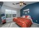 Cozy bedroom with ceiling fan, and a queen bed adorned with a patterned comforter, and window at 1002 Elm Hall Cir, Summerville, SC 29483