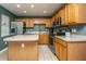 Well-equipped kitchen with oak cabinetry, stainless appliances, and green walls at 1002 Elm Hall Cir, Summerville, SC 29483