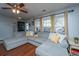 Comfortable living room with plush gray sectional, ceiling fan and natural light at 1002 Elm Hall Cir, Summerville, SC 29483