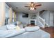 Comfortable living room featuring a fireplace, ceiling fan, and a plush gray sectional at 1002 Elm Hall Cir, Summerville, SC 29483
