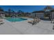 Community pool with lounge chairs, community building and nearby residences at 1002 Elm Hall Cir, Summerville, SC 29483