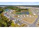 Aerial view of a residential community featuring single-Gathering homes, a pond, and green spaces at 101 Corvus Ct, Summerville, SC 29486