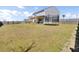 Large backyard with a privacy fence, patio cover, and trampoline, perfect for outdoor entertaining and recreation at 101 Corvus Ct, Summerville, SC 29486