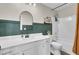 Bathroom with a white vanity, arched mirror, and a shower-tub with a dark green accent wall and brushed-nickel hardware at 101 Corvus Ct, Summerville, SC 29486