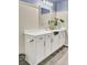 Bright bathroom featuring white cabinets with matte black hardware, a white countertop and a large decorative mirror at 101 Corvus Ct, Summerville, SC 29486