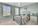 Bedroom featuring light green walls, two windows letting in lots of natural light and neutral-colored carpet at 101 Corvus Ct, Summerville, SC 29486