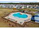 Resort-style community pool featuring lounge chairs, tables and chairs and pergolas and a playground, all surrounded by a black fence at 101 Corvus Ct, Summerville, SC 29486