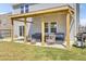 Covered patio with chairs and a grill, perfect for outdoor dining and relaxation at 101 Corvus Ct, Summerville, SC 29486