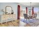 The dining room features a wooden table, chandelier, and backyard access at 101 Corvus Ct, Summerville, SC 29486