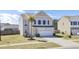 Charming two-story home features a two car garage, palm tree, and manicured lawn at 101 Corvus Ct, Summerville, SC 29486