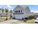 View of a two-story home showcasing its well-manicured lawn and attached two-car garage at 101 Corvus Ct, Summerville, SC 29486
