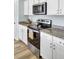 Stainless steel oven and microwave with granite countertops and white cabinets at 101 Corvus Ct, Summerville, SC 29486