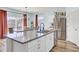 Granite kitchen island with stainless steel appliances, faucet, and backyard view at 101 Corvus Ct, Summerville, SC 29486