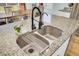 Close-up of kitchen island sink with granite countertop and stylish faucet fixture at 101 Corvus Ct, Summerville, SC 29486
