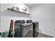 Laundry room with front-loading, stainless-steel washer and dryer, complemented by light blue walls and wood-look floors at 101 Corvus Ct, Summerville, SC 29486