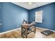 Bright office featuring a modern desk, chair, and treadmill, illuminated by natural light from the window at 101 Corvus Ct, Summerville, SC 29486