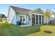 Spacious backyard featuring a screened-in back porch and well-maintained landscaping at 1028 Harriman Ln, Charleston, SC 29492