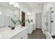 Bright bathroom featuring double vanities, modern fixtures, and a glass-enclosed shower at 1028 Harriman Ln, Charleston, SC 29492