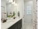 Bathroom showcasing double sinks with modern fixtures, a large mirror, and a floral shower curtain at 1028 Harriman Ln, Charleston, SC 29492