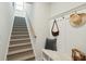 Welcoming entryway featuring carpeted stairs, bench seating, and coat hooks for added convenience at 1028 Harriman Ln, Charleston, SC 29492