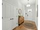 Bright entryway with hardwood floors, a decorative rug, wooden console and double-door closet at 1028 Harriman Ln, Charleston, SC 29492