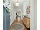 Bright entryway with hardwood floors, a decorative rug, wooden console, and a view to the living room at 1028 Harriman Ln, Charleston, SC 29492