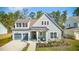 Charming two-story home with a well-manicured lawn, covered front porch and attached two car garage at 1028 Harriman Ln, Charleston, SC 29492