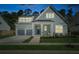 Charming two-story home with a welcoming front porch and attached two car garage at 1028 Harriman Ln, Charleston, SC 29492