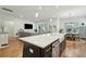 Open-concept kitchen with an island, stainless steel dishwasher, and view into the living area at 1028 Harriman Ln, Charleston, SC 29492