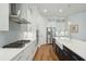 Contemporary kitchen showcasing white cabinetry, stainless appliances, and a large central island with a farmhouse sink at 1028 Harriman Ln, Charleston, SC 29492