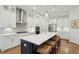 A modern kitchen featuring white cabinets, stainless steel appliances, and an island with wicker stools at 1028 Harriman Ln, Charleston, SC 29492