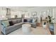 Open-concept living room featuring a comfortable sectional sofa, hardwood floors, and access to the kitchen at 1028 Harriman Ln, Charleston, SC 29492