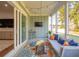 Comfortable seating area in the screened porch, perfect for relaxing and enjoying the backyard view at 1028 Harriman Ln, Charleston, SC 29492