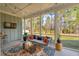 Cozy screened porch featuring comfortable seating, a decorative rug, and serene views of the backyard at 1028 Harriman Ln, Charleston, SC 29492