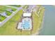 Aerial view of community pool, amenity center, playground, and surrounding green spaces next to the lake at 1144 Wading Point Blvd, Huger, SC 29450