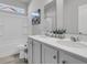 Bathroom featuring a double vanity with modern hardware, quartz countertops, tub, and a privacy window at 1144 Wading Point Blvd, Huger, SC 29450