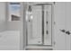 Walk-in shower with glass door plus soaking tub and window providing natural light in this bathroom at 1144 Wading Point Blvd, Huger, SC 29450