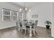 Bright dining room featuring a rustic wood table set, modern light fixture, and views from the window at 1144 Wading Point Blvd, Huger, SC 29450