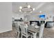 Open-concept dining area with a rustic wood table set and modern light fixture adjacent to a living room and kitchen at 1144 Wading Point Blvd, Huger, SC 29450