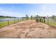 Picturesque fenced dog park with lake backdrop for canine companions and relaxation at 1144 Wading Point Blvd, Huger, SC 29450