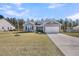 Charming single-Gathering home with a well-manicured lawn and a two-car attached garage at 1144 Wading Point Blvd, Huger, SC 29450