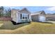 Side view of a gray single-Gathering home with green grass and landscaping at 1144 Wading Point Blvd, Huger, SC 29450