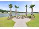 Scenic fire pit with cozy seating and beautiful lake views for outdoor enjoyment at 1144 Wading Point Blvd, Huger, SC 29450