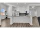 Bright kitchen with a large granite island, stainless steel appliances, and white cabinetry at 1144 Wading Point Blvd, Huger, SC 29450