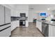 Modern kitchen with gray backsplash, granite countertops and stainless steel appliances at 1144 Wading Point Blvd, Huger, SC 29450