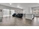 Spacious living area with hardwood floors, large windows, and a gray sofa near the dining area at 1144 Wading Point Blvd, Huger, SC 29450