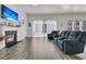 Open-concept living room with fireplace, tv, and a sliding glass door to the backyard at 1144 Wading Point Blvd, Huger, SC 29450