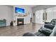 Bright living room with a cozy fireplace, hardwood floors, and large sliding glass doors at 1144 Wading Point Blvd, Huger, SC 29450
